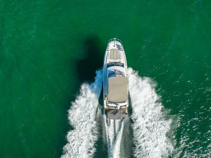 Slide: The Image of Aerial view of 2020 Prestige 420 yacht cruising on turquoise water. - 5