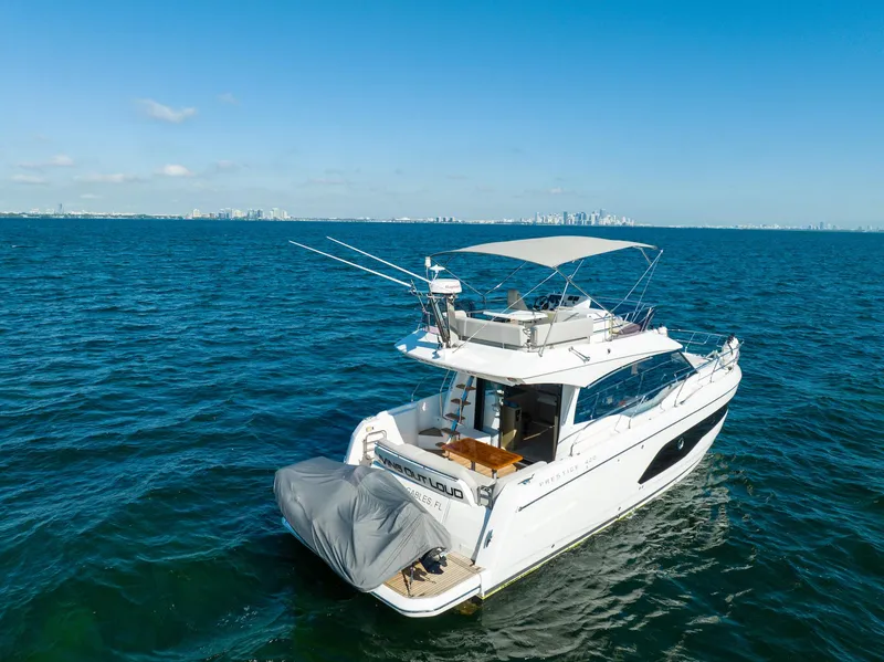 Slide: The Image of Prestige 420 yacht cruising on open sea, 2020 model, clear blue sky. - 8