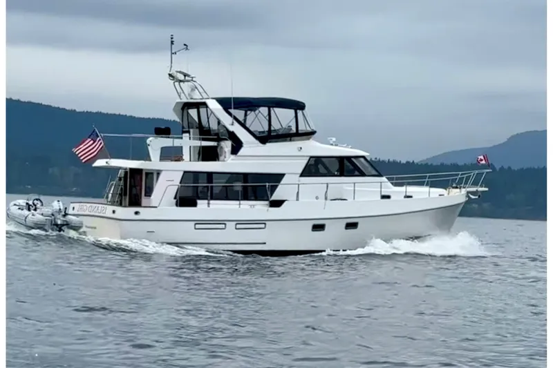 The Image of 1997 Ocean Alexander 486 Pilothouse yacht cruising on a calm sea. - 0