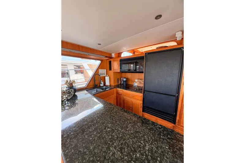 Slide: The Image of Luxurious kitchen interior of 1997 Ocean Alexander 486 Pilothouse yacht with granite countertops. - 10