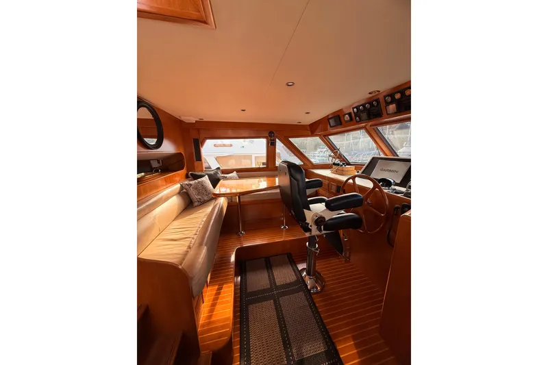 Slide: The Image of Luxurious 1997 Ocean Alexander 486 Pilothouse interior with helm and seating area. - 13