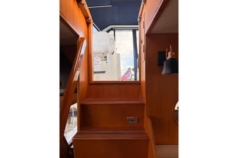 Slide: The Image of Interior stairs of 1997 Ocean Alexander 486 Pilothouse with wooden finish and nautical decor. - 19