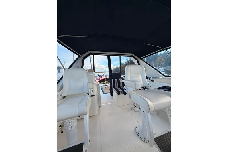 Slide: The Image of Interior of 1997 Ocean Alexander 486 Pilothouse with white seating and panoramic windows. - 20