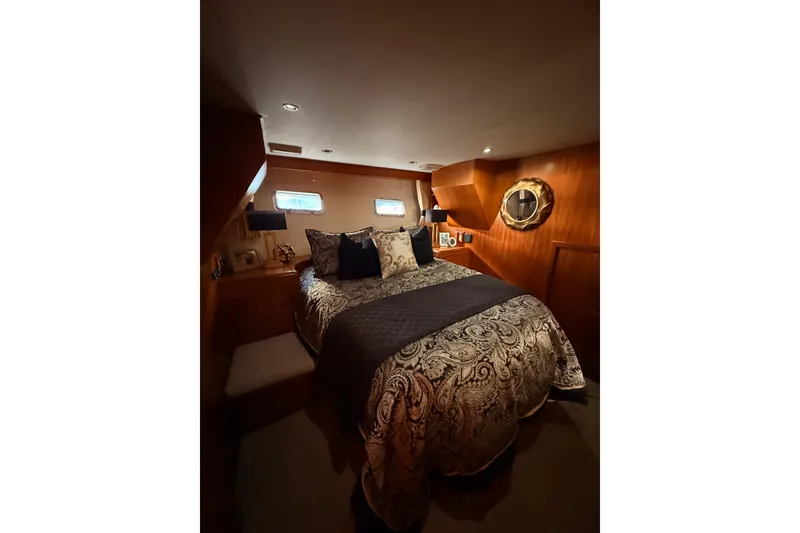 Slide: The Image of Luxurious bedroom interior of 1997 Ocean Alexander 486 Pilothouse yacht with elegant bedding. - 25