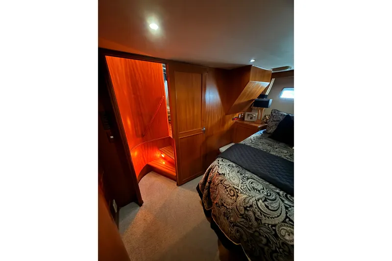Slide: The Image of Luxurious 1997 Ocean Alexander 486 Pilothouse bedroom with elegant wood finish and cozy lighting. - 26