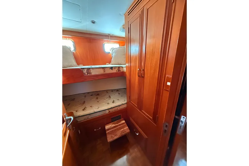 Slide: The Image of Cozy cabin interior of 1997 Ocean Alexander 486 Pilothouse with wooden bunk beds. - 32