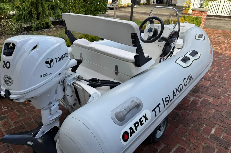Slide: The Image of Apex inflatable boat with Tohatsu engine, parked on brick driveway. Ocean Alexander 486 Pilothouse, 1997. - 46