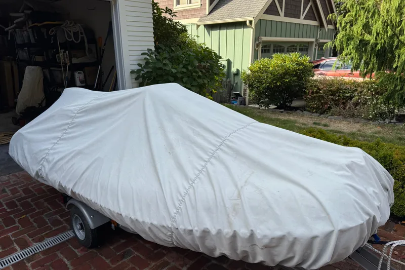 Slide: The Image of Covered Ocean Alexander 486 Pilothouse boat on trailer, parked in driveway. - 47