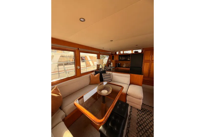 Slide: The Image of Luxurious interior of 1997 Ocean Alexander 486 Pilothouse yacht with elegant seating and dining area. - 6