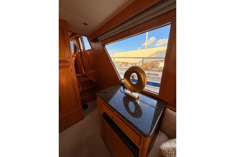 Slide: The Image of Interior of 1997 Ocean Alexander 486 Pilothouse with wooden cabinetry and decorative sculpture. - 7