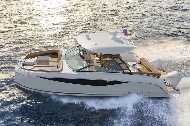 The Image of Manufacturer Provided Image: 2026 Four Winns TH33 luxury boat cruising on open water. - 0