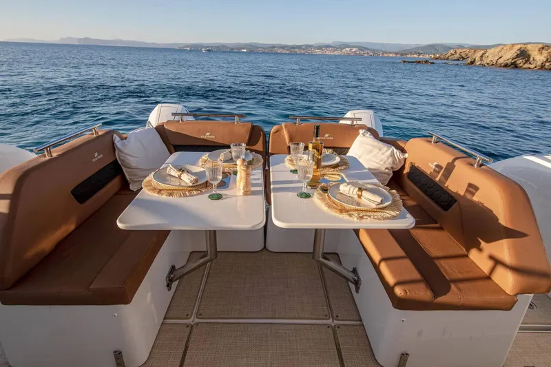 Slide: The Image of Manufacturer Provided Image: Luxurious dining setup on 2026 Four Winns TH38 yacht, overlooking serene ocean view. - 4
