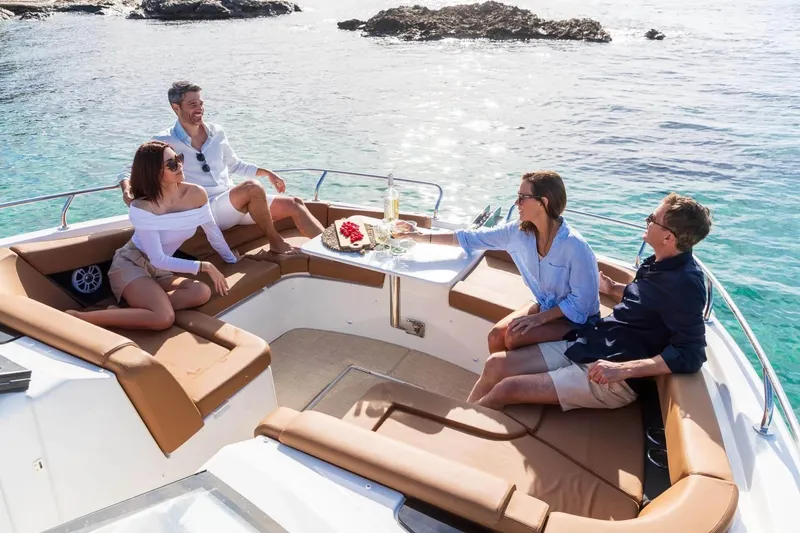 Slide: The Image of Manufacturer Provided Image: Four people relaxing on a 2026 Four Winns TH38 boat, enjoying a sunny day. - 5