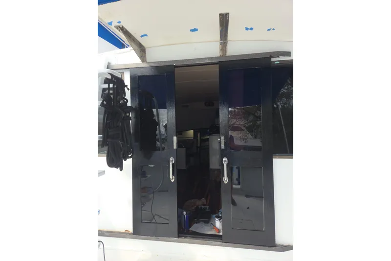 Slide: The Image of Interior of 1988 Symbol 44' Sportfish with TV, mini fridge, and storage. - 17