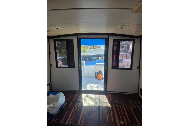 Slide: The Image of Interior of 1988 Symbol 44' Sportfish with modern wood flooring and compact kitchen area. - 18