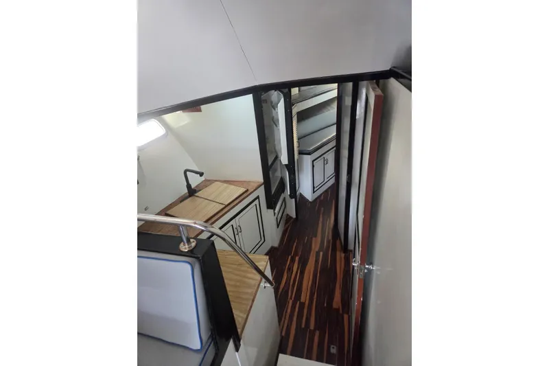 Slide: The Image of 1988 Symbol 44' Sportfish boat kitchen with microwave, sink, and wooden countertops. - 23