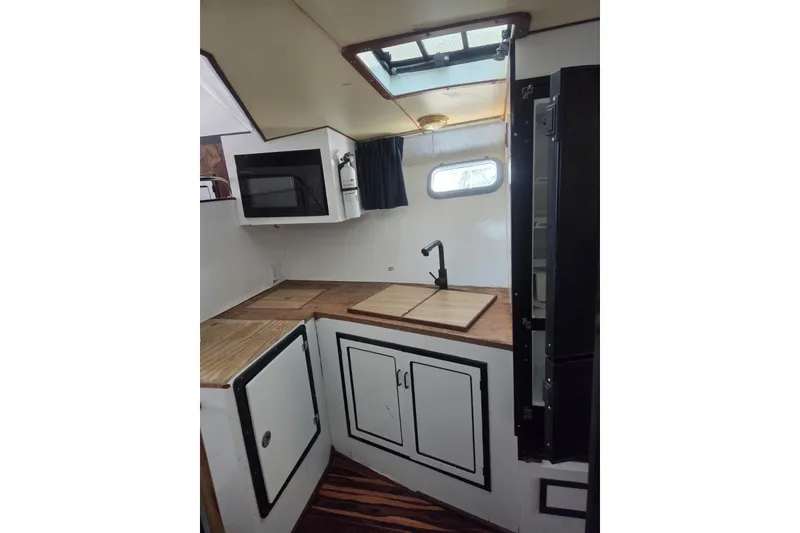 Slide: The Image of 1988 Symbol 44' Sportfish cabin interior with bed and storage. - 26