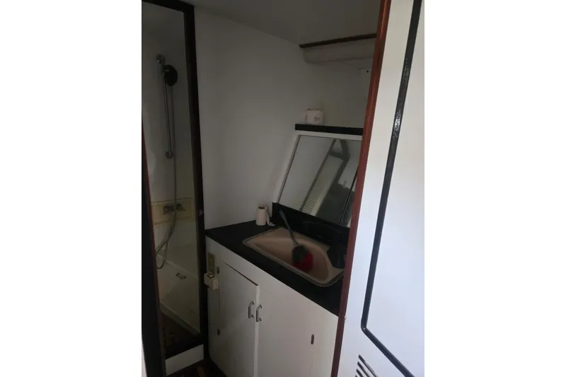 Slide: The Image of Interior of 1988 Symbol 44' Sportfish boat with modern amenities and wood flooring. - 28