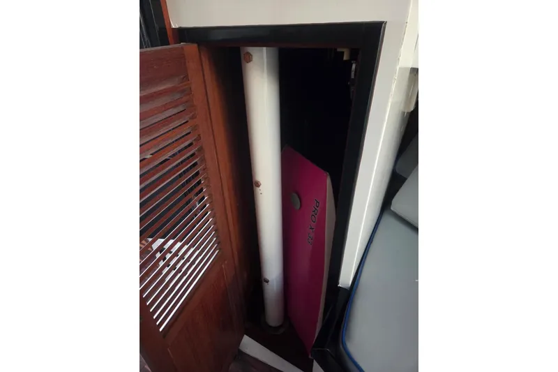 Slide: The Image of Interior of 1988 Symbol 44' Sportfish yacht, featuring compact cabinetry and wooden accents. - 30