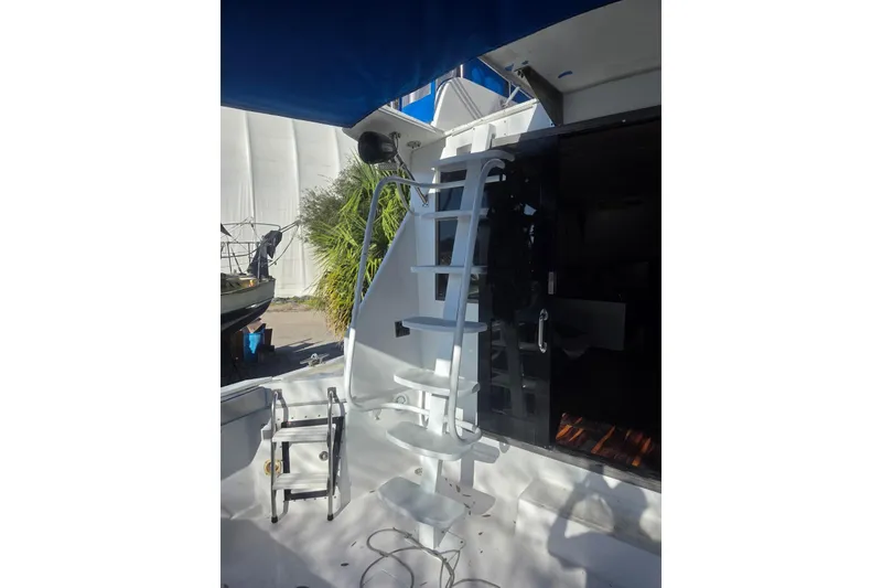 Slide: The Image of 1988 Symbol 44' Sportfish boat helm with blue canopy and control panel. - 8