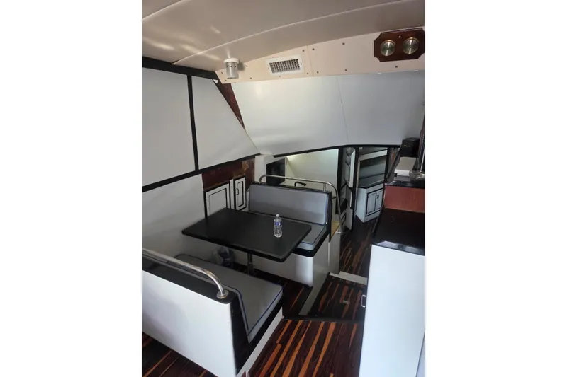 Slide: The Image of Interior of 1988 Symbol 44' Sportfish with modern wood flooring and compact kitchen area. - 17