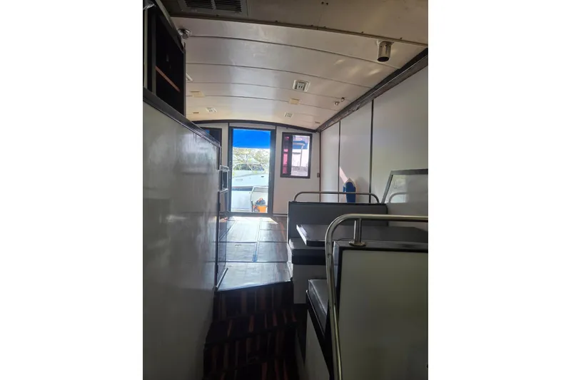 Slide: The Image of 1988 Symbol 44' Sportfish boat kitchen with microwave, sink, and wooden countertops. - 22