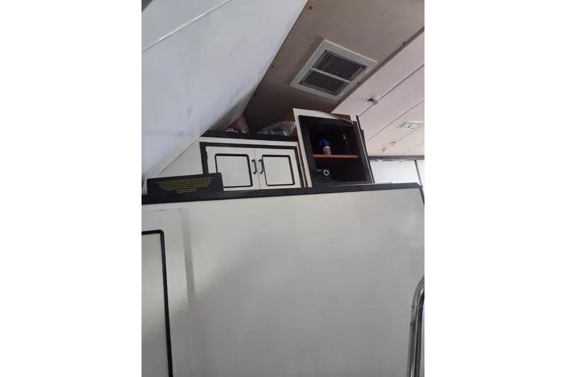 Slide: The Image of Interior cabin of 1988 Symbol 44' Sportfish with bed, mirror, and storage. - 23