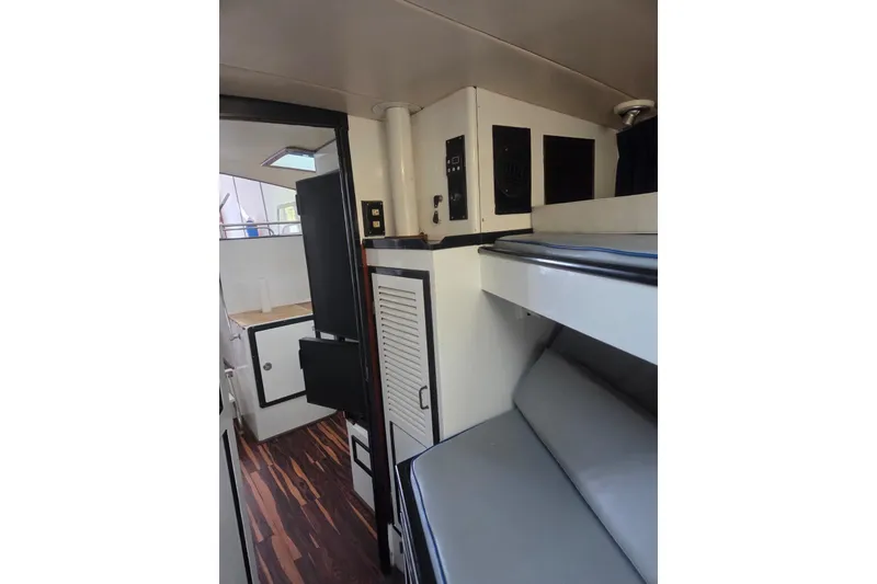 Slide: The Image of Interior of 1988 Symbol 44' Sportfish yacht, featuring compact cabinetry and wooden accents. - 29
