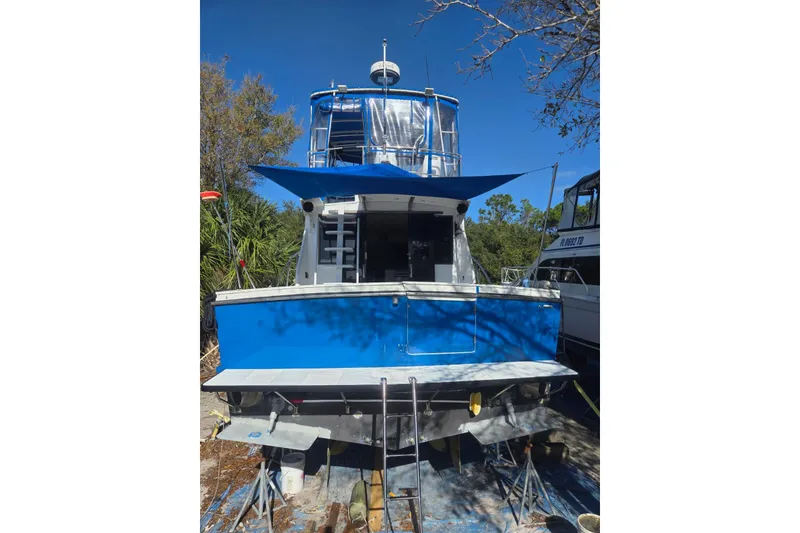 Slide: The Image of 1988 Symbol 44' Sportfish boat propeller and rudder under maintenance. - 32