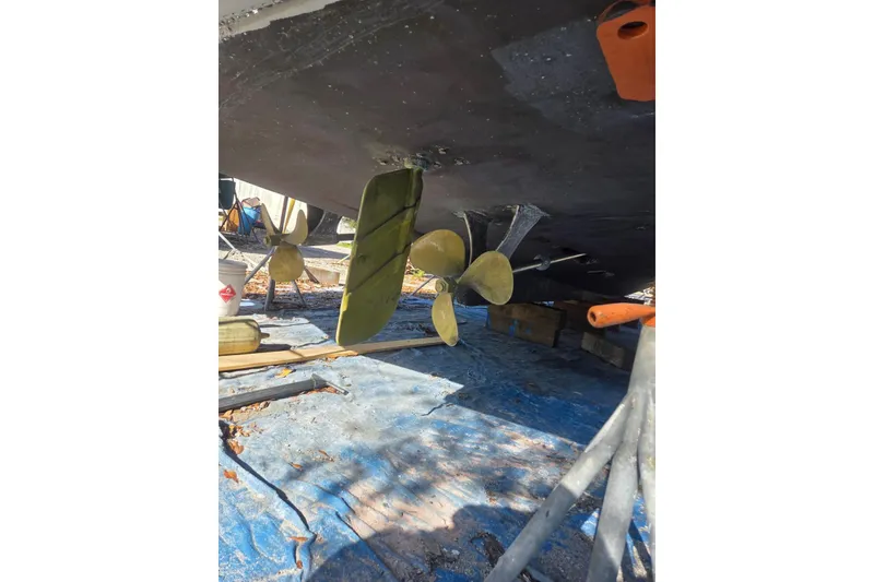 Slide: The Image of 1988 Symbol 44' Sportfish boat propeller and rudder under maintenance. - 34