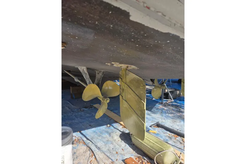 Slide: The Image of 1988 Symbol 44' Sportfish boat propeller and rudder under maintenance. - 35