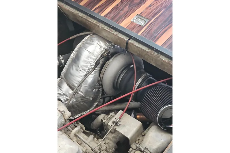 Slide: The Image of Engine compartment of a 1988 Symbol 44' Sportfish boat, featuring a turbocharger and air filter. - 37