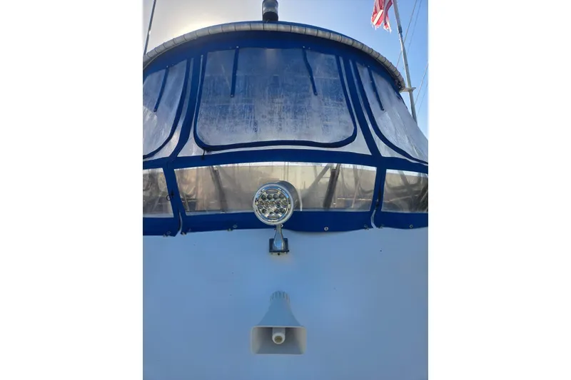 Slide: The Image of 1988 Symbol 44' Sportfish boat with blue canopy and spotlight. - 4