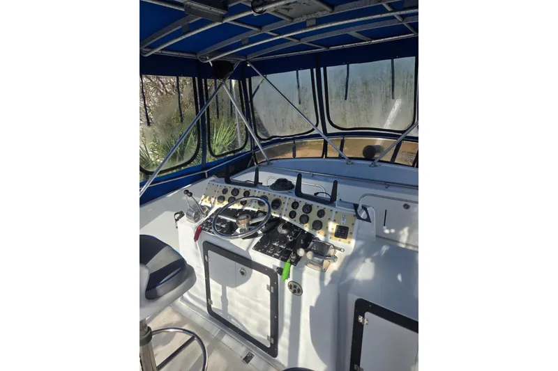 Slide: The Image of 1988 Symbol 44' Sportfish boat helm with blue canopy and control panel. - 7