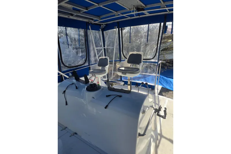 Slide: The Image of 1988 Symbol 44' Sportfish boat interior with blue canopy and seating area. - 8