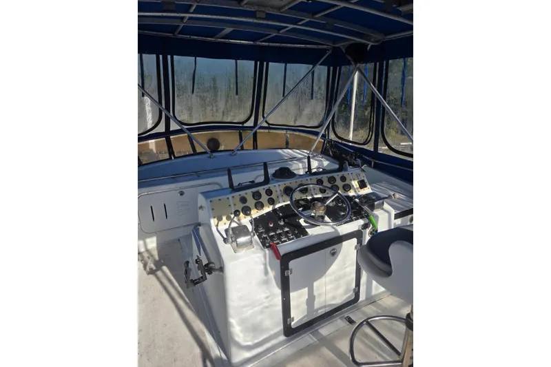 Slide: The Image of 1988 Symbol 44' Sportfish boat helm with steering wheel and control panel. - 9