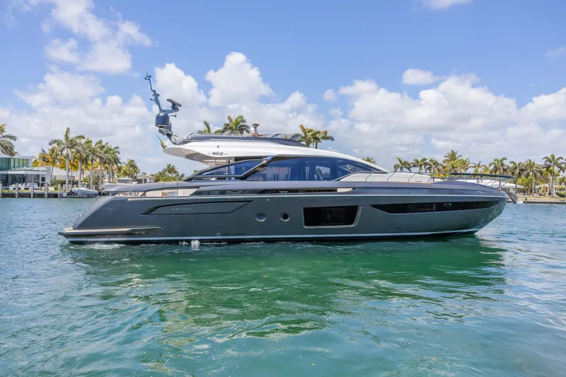 The Image of 2023 Azimut S8 yacht on clear water with palm trees and blue sky. - 0