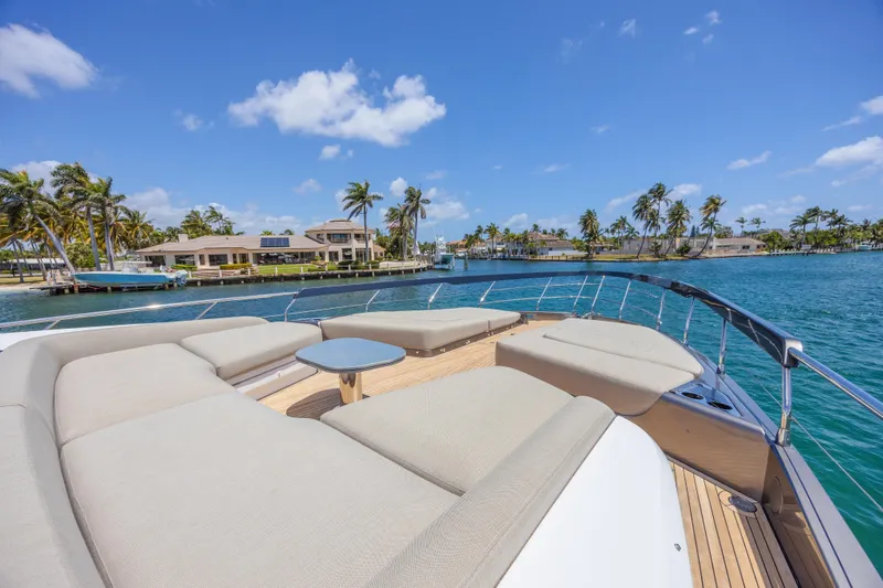 Slide: The Image of Luxurious 2023 Azimut S8 yacht deck with plush seating, overlooking tropical waterfront scenery. - 17