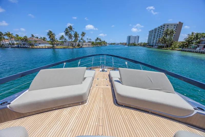 Slide: The Image of 2023 Azimut S8 yacht deck with luxurious seating, overlooking serene blue waters and palm trees. - 20
