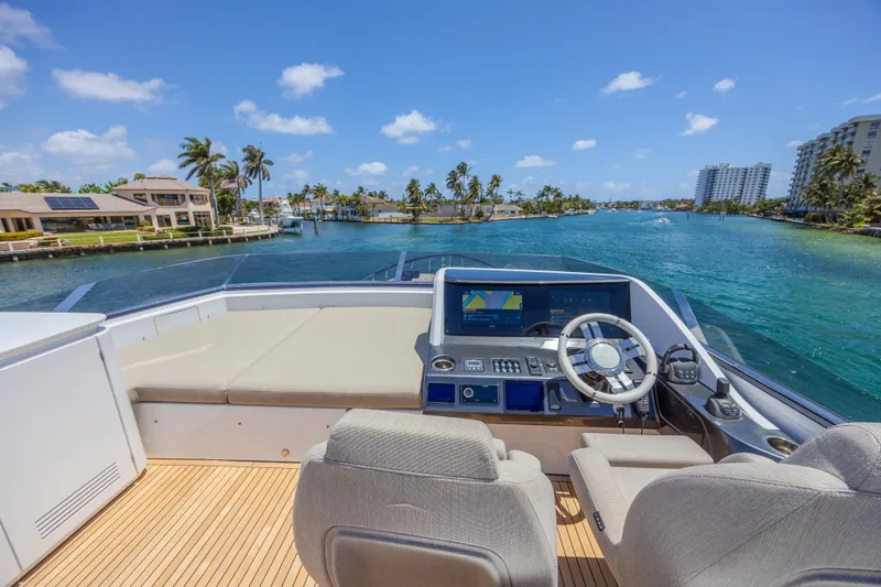 Slide: The Image of Cockpit view of 2023 Azimut S8 yacht, featuring modern controls and scenic waterfront. - 27