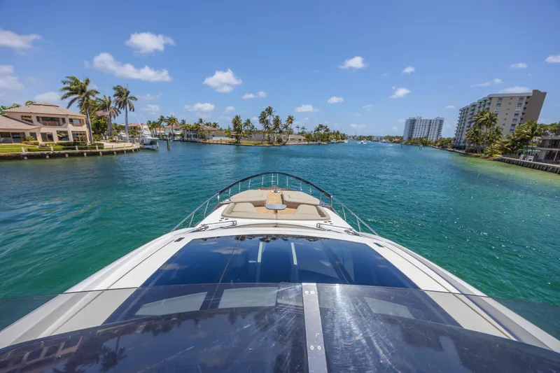 Slide: The Image of 2023 Azimut S8 yacht cruising through a scenic, tropical waterway. - 29