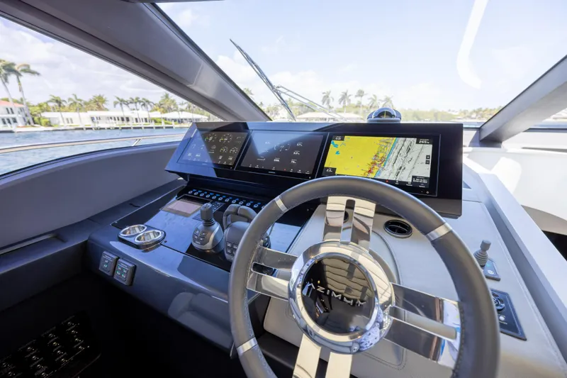 Slide: The Image of 2023 Azimut S8 yacht helm with advanced navigation displays and sleek steering wheel design. - 40