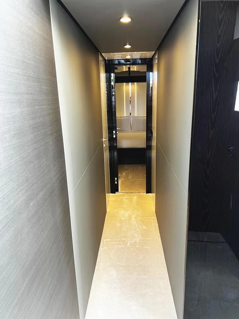 Slide: The Image of 2023 Azimut S8 yacht interior hallway with modern lighting and sleek design. - 47