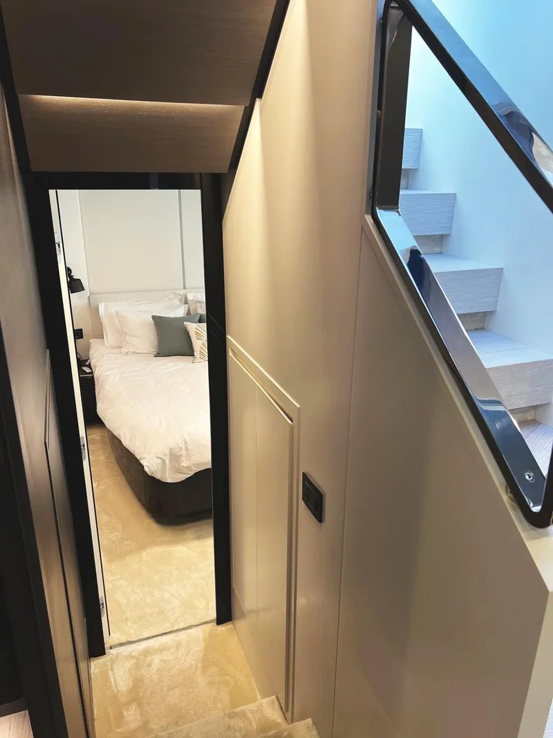 Slide: The Image of 2023 Azimut S8 yacht interior with modern staircase and cozy bedroom. - 48