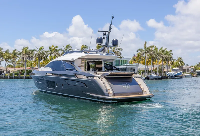 Slide: The Image of 2023 Azimut S8 yacht cruising on a sunny day with palm trees in the background. - 7