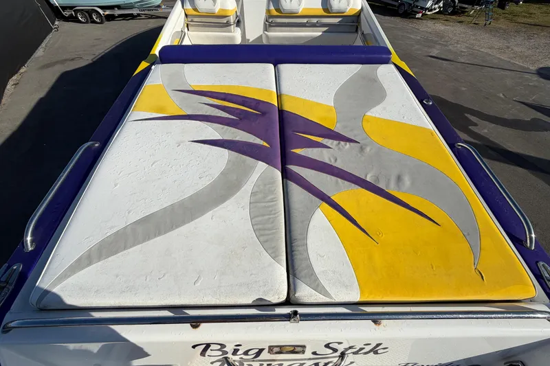 Slide: The Image of 1999 Black Thunder XT-430 boat with vibrant yellow, purple, and gray upholstery design. - 10