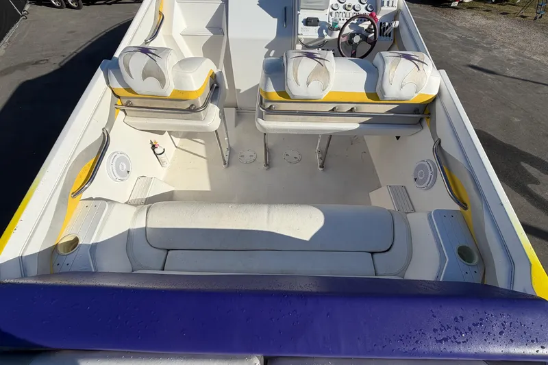 Slide: The Image of Interior of a 1999 Black Thunder XT-430 boat with white and yellow seating. - 12