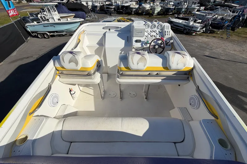Slide: The Image of 1999 Black Thunder XT-430 boat interior with white and yellow seating, dashboard, and controls. - 13