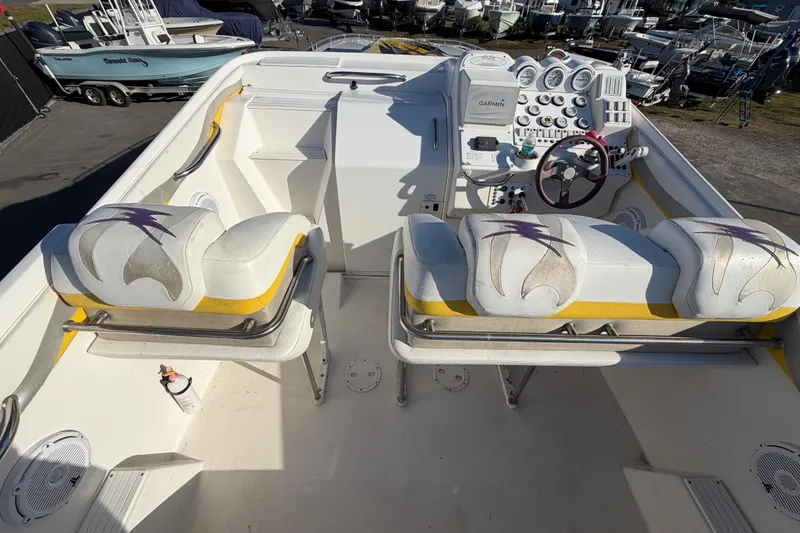 Slide: The Image of 1999 Black Thunder XT-430 boat interior with white seats and control panel. - 14