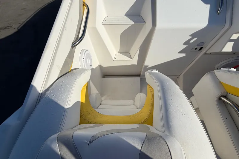 Slide: The Image of Interior of a 1999 Black Thunder XT-430 boat with white and yellow seating. - 16